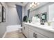 Well-lit bathroom with a double vanity, modern fixtures, and patterned tile accents at 842 Creeping Fig St, Apopka, FL 32703