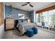 Comfortable bedroom with wood trim accent wall, large window with custom blinds, and plenty of storage at 842 Creeping Fig St, Apopka, FL 32703