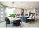 Open-concept dining room featuring modern lighting and a view into a stylish kitchen at 842 Creeping Fig St, Apopka, FL 32703