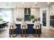 Modern kitchen with a large island, pendant lighting, and counter seating for casual dining at 842 Creeping Fig St, Apopka, FL 32703