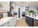 Bright, modern kitchen with stainless steel appliances, white cabinetry, and a stylish blue backsplash at 842 Creeping Fig St, Apopka, FL 32703