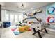 Modern living room featuring a foosball table, a colorful rug, and contemporary decor at 842 Creeping Fig St, Apopka, FL 32703