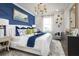 This main bedroom features a blue accent wall, stylish decor, and a tray for breakfast in bed at 842 Creeping Fig St, Apopka, FL 32703