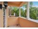 Outdoor balcony with stone railings and pillars, offering a tropical view of palm trees at 8430 Leatherleaf Ln, Orlando, FL 32827