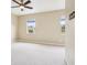 Bright bedroom with neutral walls, ceiling fan and carpet, and two windows at 8430 Leatherleaf Ln, Orlando, FL 32827
