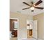 View of the bedroom and adjoining bathroom and kitchen with ceiling fan and neutral paint at 8430 Leatherleaf Ln, Orlando, FL 32827