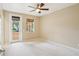 Bright, carpeted bedroom with windows and a door leading to a balcony with natural light at 8430 Leatherleaf Ln, Orlando, FL 32827