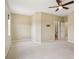 Large bedroom features a ceiling fan, neutral carpet, ensuite bathroom, and a lot of natural light at 8430 Leatherleaf Ln, Orlando, FL 32827