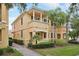 Beautiful two-story home featuring a balcony, lush landscaping, and a well-manicured lawn at 8430 Leatherleaf Ln, Orlando, FL 32827