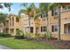 Charming two-story home with a well-manicured lawn and lush tropical landscaping at 8430 Leatherleaf Ln, Orlando, FL 32827