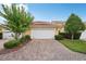 Home exterior featuring a brick driveway and well-maintained landscaping at 8430 Leatherleaf Ln, Orlando, FL 32827