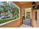Covered front porch offering a view of the community, landscape and a decorative gate at 8430 Leatherleaf Ln, Orlando, FL 32827