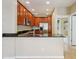 Open kitchen with stainless steel appliances, granite countertops, and dark wood cabinetry at 8430 Leatherleaf Ln, Orlando, FL 32827