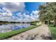 Scenic view of the lake, with walking path and lush landscaping, creating a tranquil and picturesque setting at 8430 Leatherleaf Ln, Orlando, FL 32827