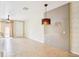 Inviting living room with tile floors, stylish pendant lighting, and seamless flow to the outdoor patio at 8430 Leatherleaf Ln, Orlando, FL 32827