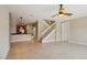 Spacious living room showcasing tile floors, staircase, and seamless flow to the kitchen at 8430 Leatherleaf Ln, Orlando, FL 32827