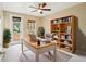 Bright office with desk, bookshelf, and natural light from the windows and door at 8430 Leatherleaf Ln, Orlando, FL 32827