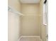 A neutral painted walk-in closet featuring a wire shelf, a hanging rack, and carpeted floor at 8430 Leatherleaf Ln, Orlando, FL 32827