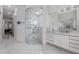 Modern marble bathroom featuring a glass-enclosed shower, dual sinks with elegant fixtures, and a sleek design at 9062 Dancy Tree Ct, Orlando, FL 32836