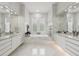 Luxurious marble bathroom with dual sinks, soaking tub, large mirrors, and ample storage space in white cabinets at 9062 Dancy Tree Ct, Orlando, FL 32836