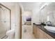 Bathroom featuring double vanity, marble floors and countertops, access to toilet and glass shower, with views to another room at 9062 Dancy Tree Ct, Orlando, FL 32836