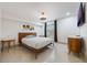 Minimalist bedroom with a wooden bed frame, modern light fixture, and stylish side tables at 9062 Dancy Tree Ct, Orlando, FL 32836