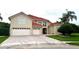 Charming home with a red tile roof, 3-car garage, and brick-paved driveway at 9062 Dancy Tree Ct, Orlando, FL 32836