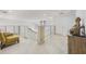 Upstairs hallway with stone floors, modern railings, seating area, and a decorative Buddha statue at 9062 Dancy Tree Ct, Orlando, FL 32836