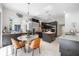 Modern kitchen features dark cabinetry, granite countertops, stainless steel appliances, and an island at 9062 Dancy Tree Ct, Orlando, FL 32836