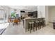 Modern kitchen features a breakfast bar, dark cabinetry, granite countertops, stainless steel appliances at 9062 Dancy Tree Ct, Orlando, FL 32836