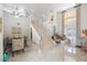 Bright living room featuring a staircase, dining table, and elegant decor with access to a pool at 9062 Dancy Tree Ct, Orlando, FL 32836