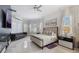 Bright main bedroom featuring a luxurious bed, sitting area, and elegant window treatments at 9062 Dancy Tree Ct, Orlando, FL 32836