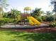 Playground featuring multiple slides, climbing structures, and soft, impact-absorbing ground at 9062 Dancy Tree Ct, Orlando, FL 32836