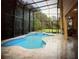 Enclosed pool and jacuzzi with tiled deck, offering a private and relaxing oasis at 9062 Dancy Tree Ct, Orlando, FL 32836