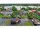 Aerial view of this lakeside home with a private dock, boat house, and pool at 9146 Bay Point Dr, Orlando, FL 32819