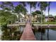 View of a backyard with pool area as seen from the private wooden dock at 9146 Bay Point Dr, Orlando, FL 32819