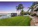Lush green lawn showcasing an outdoor area with a pool and waterfront views at 9146 Bay Point Dr, Orlando, FL 32819
