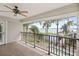 Balcony showcasing water views, black metal railing, and ceiling fan at 9146 Bay Point Dr, Orlando, FL 32819