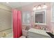 Bathroom with a shower/tub and vanity with white cabinets and counter, and a large window at 9146 Bay Point Dr, Orlando, FL 32819