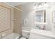 Bathroom with tiled shower, vanity sink, and ample lighting at 9146 Bay Point Dr, Orlando, FL 32819