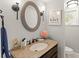 Updated bathroom with granite countertop, decorative mirror, and modern fixtures create a clean and inviting space at 9146 Bay Point Dr, Orlando, FL 32819