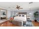 Elegant bedroom featuring a tufted headboard, ceiling fan, and wood floors at 9146 Bay Point Dr, Orlando, FL 32819