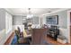 Dining room featuring chandelier, modern decor, and hardwood flooring at 9146 Bay Point Dr, Orlando, FL 32819