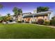 Well-maintained home exterior with manicured lawn, mature trees, and a peek at the backyard pool at 9146 Bay Point Dr, Orlando, FL 32819