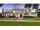 Beautiful two-story home with manicured lawn, a brick walkway, black shutters, and a two-car garage at 9146 Bay Point Dr, Orlando, FL 32819