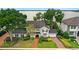 Stately two-story home featuring mature trees, a brick driveway, and an attached two-car garage at 9146 Bay Point Dr, Orlando, FL 32819