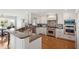 Bright kitchen featuring white cabinetry, granite countertops, stainless steel appliances, and hardwood flooring at 9146 Bay Point Dr, Orlando, FL 32819
