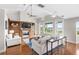 Open-concept living room with a built-in fireplace, a ceiling fan, and water views at 9146 Bay Point Dr, Orlando, FL 32819