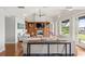 Bright living room featuring wood floors, built-in shelving, a fireplace, and water views at 9146 Bay Point Dr, Orlando, FL 32819
