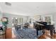 Living room with a piano, elegant decor, fireplace, and sliding doors to a pool at 9146 Bay Point Dr, Orlando, FL 32819